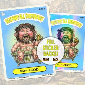 May include: Two trading cards with a cartoon illustration of a figure in a bathtub, with the text "DESTROY ALL CREATURES" and "BATH of GOD". The cards have a blue background and a circular sticker that says "FOIL STICKER BACKS!"