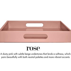 May include: A rectangular dusty pink tray with a smooth finish and two integrated oval handles on the sides. The text below the tray reads: rose. A dusty pink with subtle beige undertones that lends a softness, which pairs beautifully with both neutral palettes and more vibrant accents.
