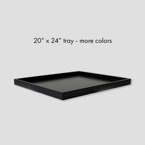 May include: A rectangular black tray with raised edges. The text 20" x 24" tray - more colors is printed above the object. The tray has a smooth, flat surface and a solid black finish, presented from a slightly elevated perspective.