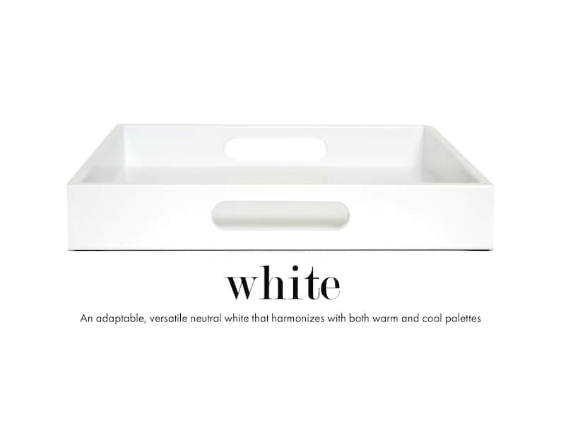 May include: A rectangular white tray with a smooth finish and two integrated oval handles on the sides. Below the tray, the text reads: white. An adaptable, versatile neutral white that harmonizes with both warm and cool palettes.