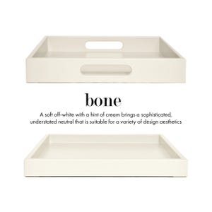 May include: A rectangular off-white tray with a smooth finish and cut-out handles on the sides. The text bone is printed in black above a description that reads: A soft off-white with a hint of cream brings a sophisticated, understated neutral that is suitable for a variety of design aesthetics.