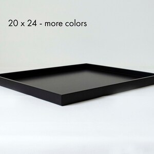 May include: A black rectangular tray with a raised edge. The tray measures 20 x 24 inches.  20 x 24 - more colors
