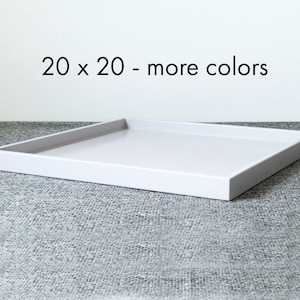 May include: White square serving tray with a 20 x 20 inch size. The tray is on a gray textured surface. 20 x 20 - more colors