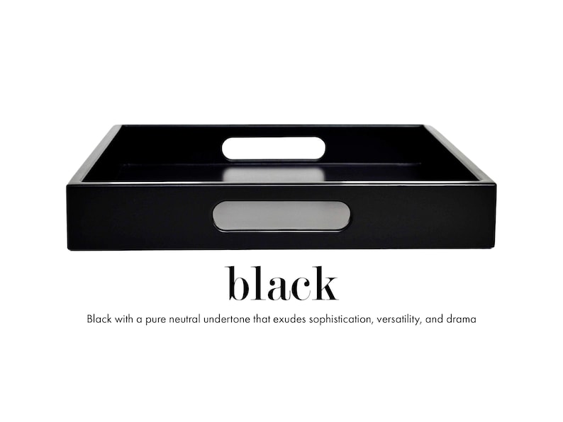 May include: A rectangular black serving tray with a smooth, solid finish and two integrated oval handles on the sides. Below the tray, the text reads: black. Black with a pure neutral undertone that exudes sophistication, versatility, and drama.