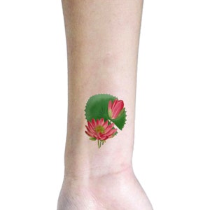 pink lotus tattoo pieced on wrist