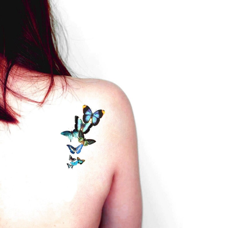 blue flying butterflies temporary tattoo pieced on the back