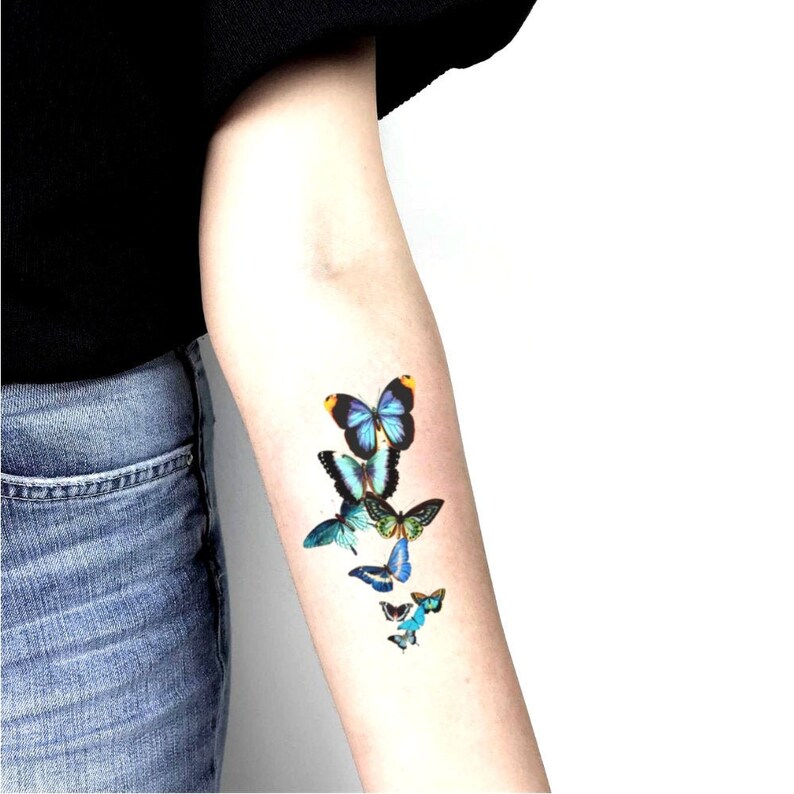 blue flying butterflies temporary tattoo pieced on arm