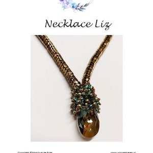 May include: A gold chain necklace with a teardrop-shaped crystal pendant. The pendant is surrounded by small green and gold beads.