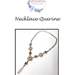 May include: A silver necklace with a long pendant and black and white beads. The necklace is called "Necklace Quirine".