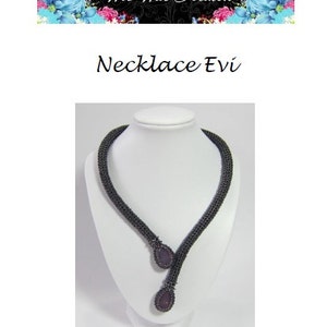 May include: A dark grey beaded necklace with two purple gemstone pendants. The necklace is displayed on a white mannequin bust.