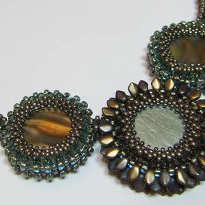 May include: A beaded necklace with three circular pendants. The pendants are made of brown and green beads and feature a round, iridescent stone in the center.