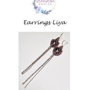 May include: A pair of silver earrings with pink and purple beaded teardrop-shaped charms. The earrings have long, delicate chains.
