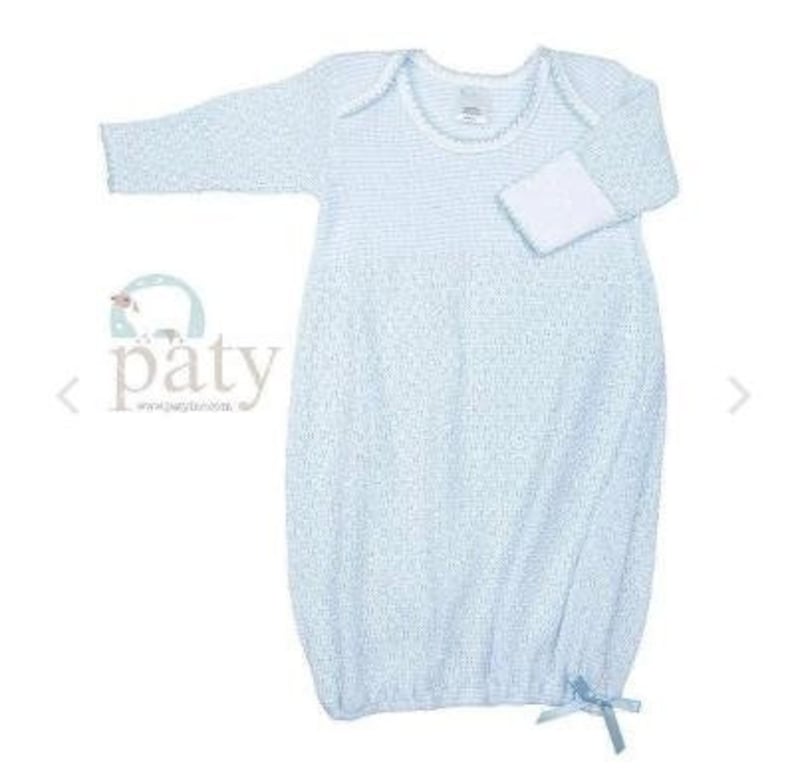 May include: A light blue baby gown with a textured knit pattern and white cuffs. The gown features a round neckline, long sleeves, and a small bow at the bottom. The brand name "paty" is visible on the left side.
