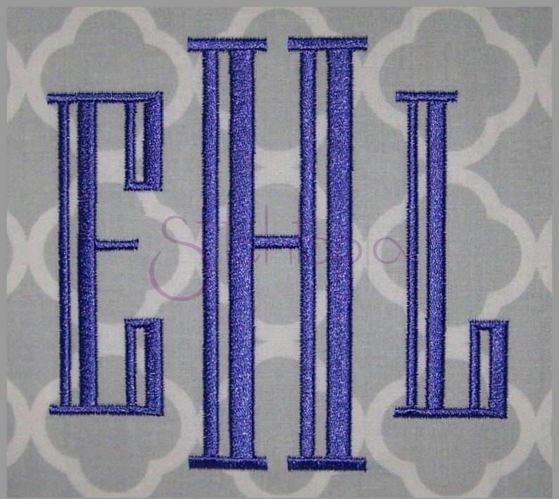 May include: Monogrammed design featuring the letters EHL in a bold, stylized font. The letters are a vibrant blue, embroidered on a light gray fabric with a repeating white quatrefoil pattern. The design is centered and stands out.
