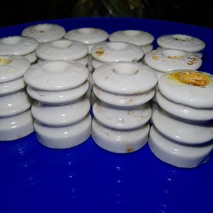Farm Master Porcelain Insulators - 12 notched circular form 1.25" diam. 1.5" high w notched edges - possible crossovers