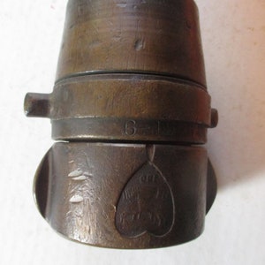 May include: A vintage brass lock with a heart-shaped design and the number "6-197" engraved on the side.