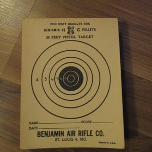 May include: Vintage Benjamin H.C. Pellets 25 Feet Pistol Target. The target features concentric circles with numbers 4 through 9, and text that reads "FOR BEST RESULTS USE BENJAMIN H C PELLETS". The target also includes spaces for name and score.
