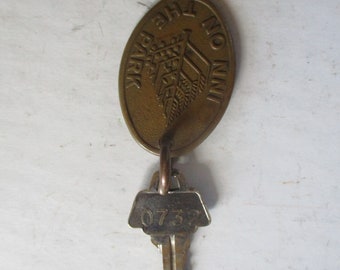 Hotel Keychains - souvenir of Inn on the Park of Toronto - 2.1" oval brass fob with with room key 0732.
