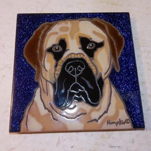 May include: Square ceramic tile featuring a detailed portrait of a Mastiff dog. The dog's face is rendered in shades of tan, brown, and black against a speckled blue background. The tile is signed "Rumpkin" in the lower right corner.