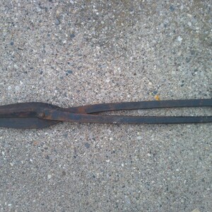 May include: A rusty metal pair of shears with a long handle. The shears are used for cutting metal.