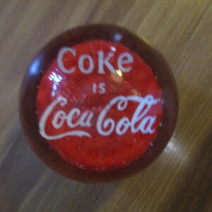 Coke is Coca-Cola - glass ball paperweight - 3.5&quot; diameter orb with red base below white text