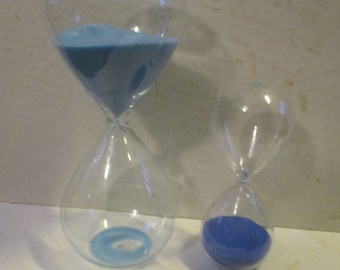 Hourglass set of 2 - 30 min and 15 min forms with 2 different blue sand fillers - 8&quot; and 5&quot; high forms - fun functional decor
