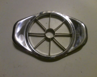 May include: A silver metal apple slicer with eight blades and a central core remover.