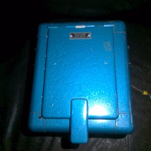 May include: A blue metal box with a handle and a white label that says "Remarkable".