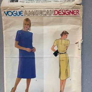 May include: A vintage sewing pattern for a dress, featuring two illustrations of women wearing the dress. The pattern is titled "Vogue American Designer" and is designed by Jerry Silverman. The pattern number is 2454 and the price is $4.50.