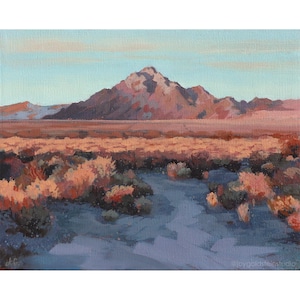 A painting of a desert sunset with a mountain in the distance, a trail in the foreground and desert brush. Sunset colors of orange, pinks, purples and blues are painted in an impressionistic manner.