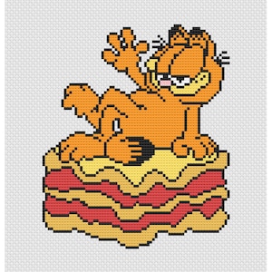 May include: Cross-stitch design featuring Garfield the cat sitting on a lasagna. The orange cat is waving with a grumpy expression. The lasagna has layers of yellow, red, and black. The background is white.