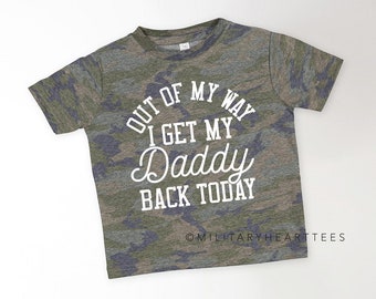 May include: A camouflage-patterned t-shirt with the text "Out of my way I get my Daddy back today" in white lettering.