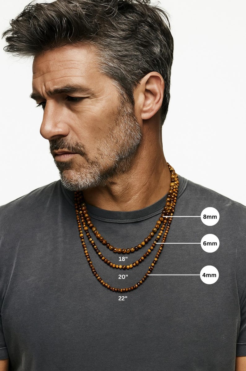 May include: Three beaded necklaces with varying bead sizes (4mm, 6mm, and 8mm) and lengths (18", 20", and 22"). The necklaces are a warm brown color and are displayed on a person wearing a gray t-shirt.