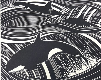 Linocut print of Orca whales