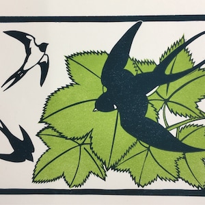 May include: A black and green linocut print of two birds in flight and one bird perched on a branch of green leaves.