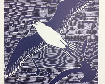 Linocut print of flying seagulls