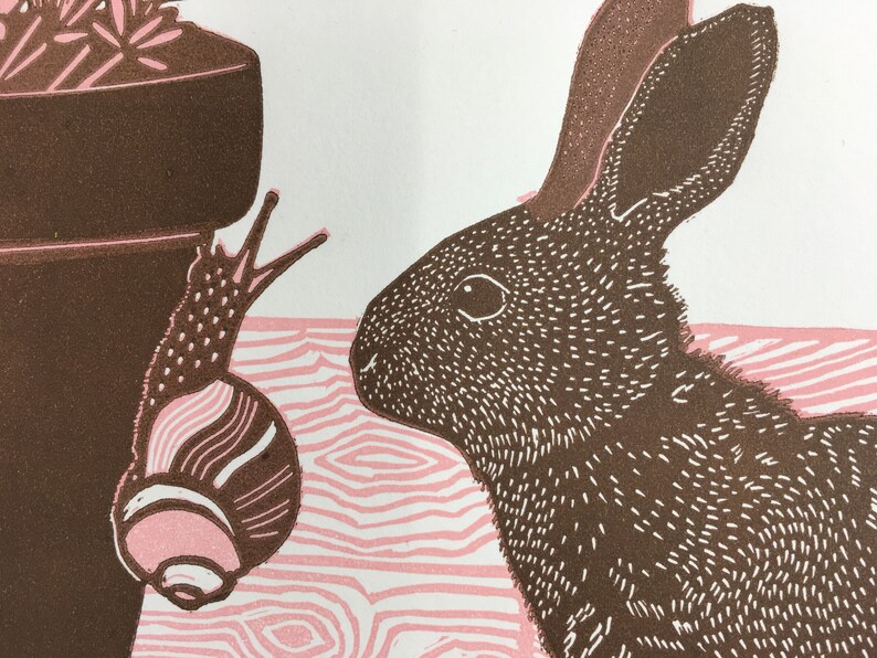 Linocut print of a baby rabbit looking at a snail image 2