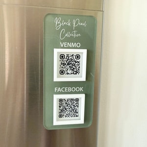 May include: A green and white sign with the text "Black Pearl Collective" and the words "Venmo" and "Facebook" with QR codes underneath.