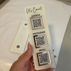 May include: White acrylic sign with the text "Let's Connect" at the top. The sign has three sections with QR codes for Google, Instagram, and Menu.