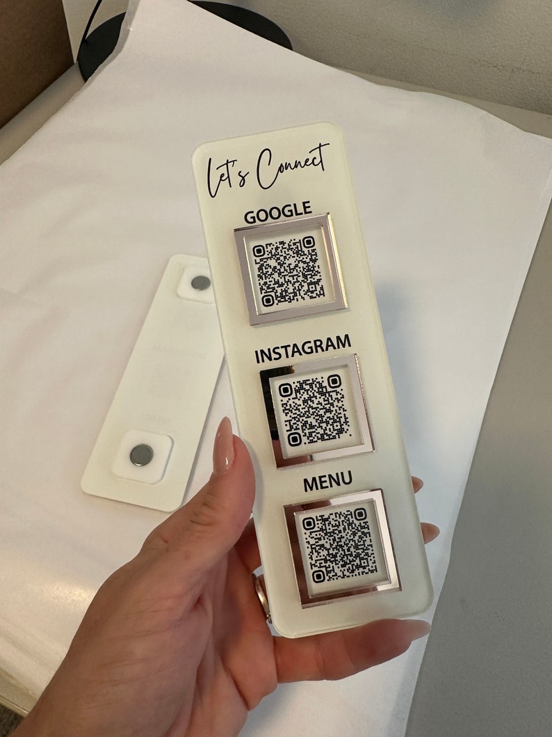 May include: White acrylic sign with the text "Let's Connect" at the top. The sign has three sections with QR codes for Google, Instagram, and Menu.