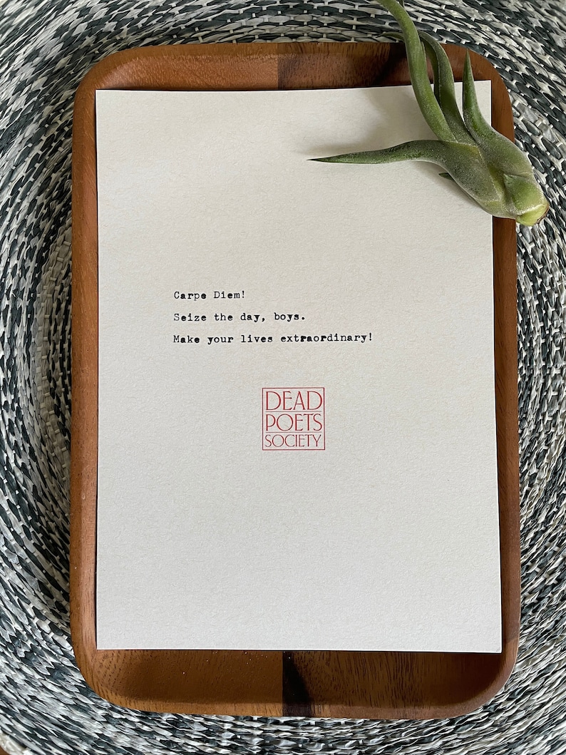 May include: A white card with the text "Carpe Diem! Seize the day, boys. Make your lives extraordinary!" and a red stamp that says "DEAD POETS SOCIETY".