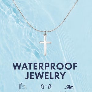 May include: A silver-toned cross pendant on a delicate chain. The text WATERPROOF JEWELRY appears below, followed by three icons representing shower, sweat, and swimming resistance with the labels Shower Resistant, Sweat Resistant, and Swimming Resistant.