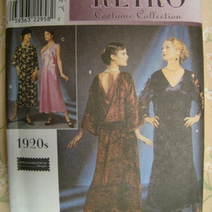 May include: Simplicity Retro Costume Collection sewing pattern featuring 1920s designs. The pattern includes illustrations of dresses in various styles. The cover has the text "RETRO Costume Collection" and the size is N 10, 12, 14.
