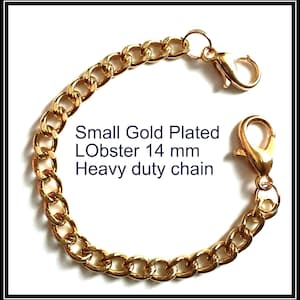 May include: A gold-plated chain featuring a series of interlocking oval links and two lobster claw clasps. The text Small Gold Plated LObster 14 mm Heavy duty chain is printed in the center of the curved chain, which is arranged in a circular shape.