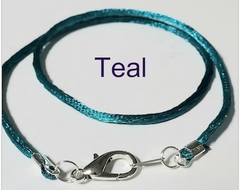 May include: Teal cord necklace with a silver lobster clasp.