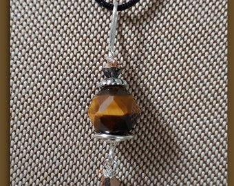 Tiger Eye Minnie wire wrapped pendant corded on 1 mm black Satin Cord. Non tarnish silver wire,Lobster claw clasp.