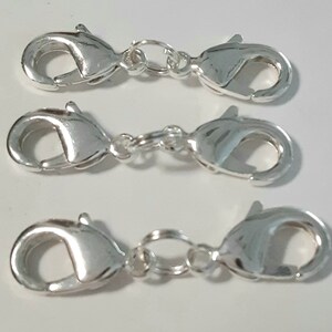 May include: Three silver-toned lobster claw clasps with jump rings. These clasps are commonly used for jewelry making.