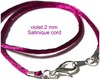 May include: A close-up of a violet satin cord with a silver clasp. The cord is 2 mm thick and is a vibrant shade of purple. The text "violet 2 mm Satinique cord" is visible in the image.