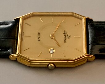Mens Delma Les Supremes Watch: 18K Gold Plate Swiss Click & Read