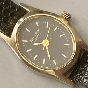 Vintage Sharp Black Dial Watch: Womens Oval Gold Tone Bezel